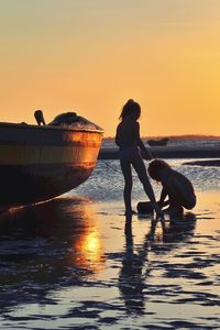 People on beach at sunset