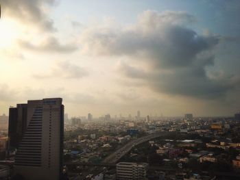 Skyscrapers against cloudy sky