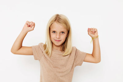 Portrait of smiling young woman gesturing against white background