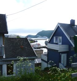 Houses in city against sky