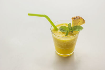 Sweet and refreshing pineapple smoothie on white background