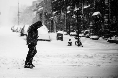 Person standing on snow covered field