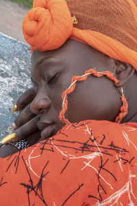 Ghana women rest on a stone wall in takoradi ghana