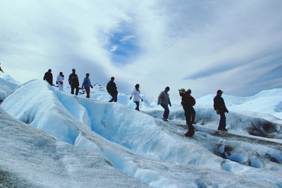 Group of people on snow covered landscape