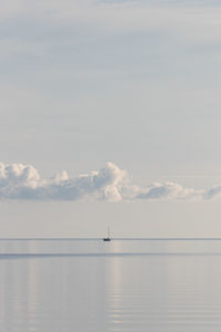 Scenic view of sea against sky with sail boat