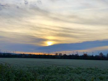 Scenic view of field against sky during sunset