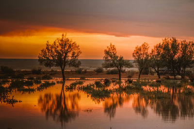 Scenic view of lake against orange sky