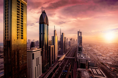 Panoramic view of buildings in city during sunset