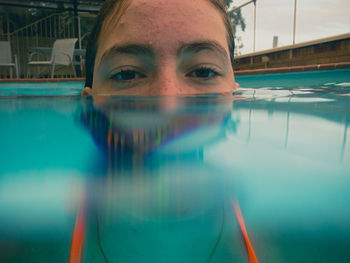 Close-up portrait of girl swimming in pool