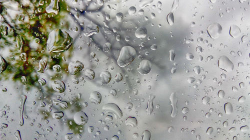 Full frame shot of wet glass window during rainy season