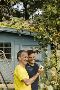 Man and woman standing by plants