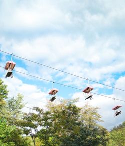 Low angle view of hanging from tree against sky