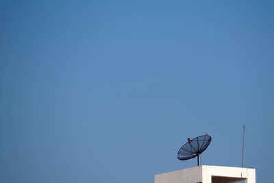 Low angle view of basketball hoop against clear blue sky