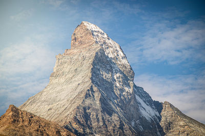 Low angle view of snow covering mountain against sky