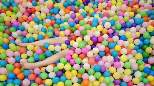 Person buried under colorful balls
