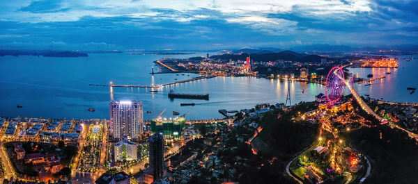 High angle view of city lit up at night