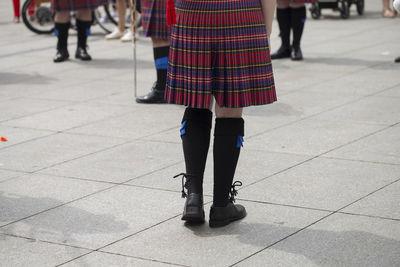 Low section of women standing on street