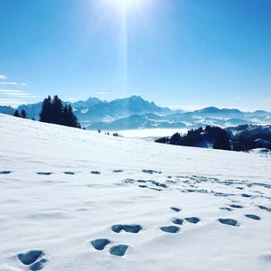 Scenic view of snow covered landscape against sky