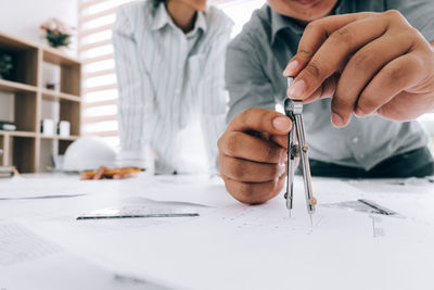 Midsection of man working on table