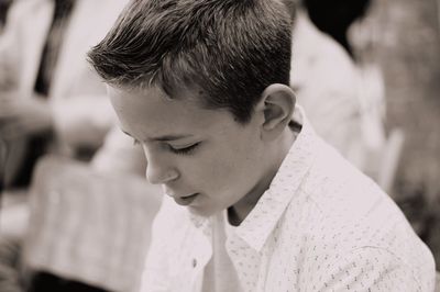 Close-up portrait of boy looking away outdoors