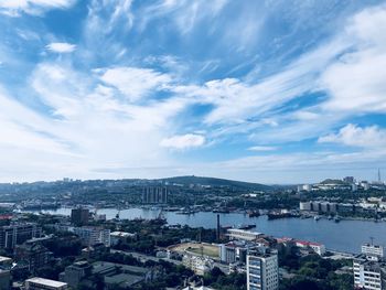 High angle view of buildings by sea against sky