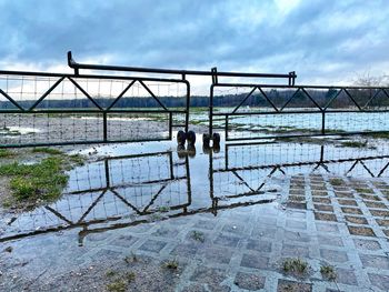People on bridge against sky