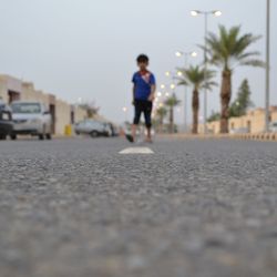 Young woman walking on road