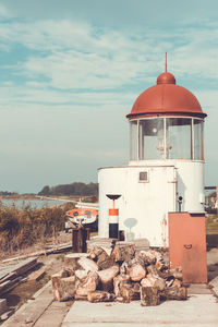 Buildings by sea against sky