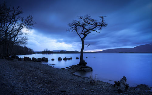 Scenic view of sea against sky at dusk