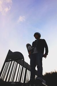 Low angle view of man standing against sky
