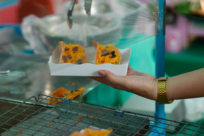 Woman serving food in container at stall