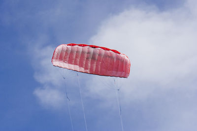 Low angle view of parachute against blue sky