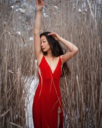 Young beautiful asian girl with natural make up in red silk dress in winter outdoor.