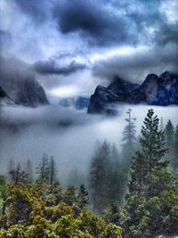 Scenic view of mountains against cloudy sky