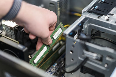 Close-up of teenager assembling personal computer