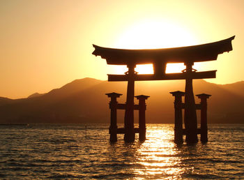 Silhouette of temple against sky during sunset
