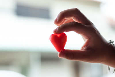 Close-up of hand holding heart shape