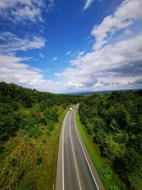 Empty road along countryside landscape