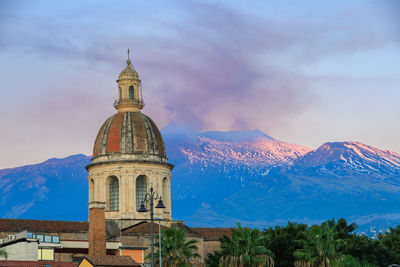 Church against sky devastated by the eruption of the etna volcano