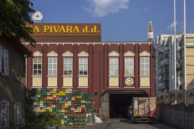 Information sign on street against buildings in city