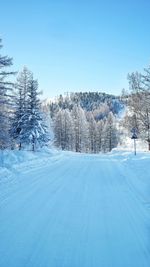 Scenic view of snow covered field against sky