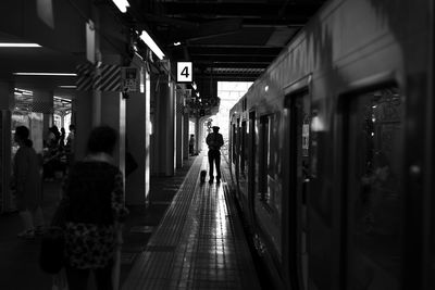 People walking on railroad station platform