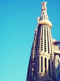 Low angle view of tower against blue sky