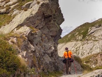 Rear view of man standing on rock