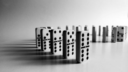Close-up of dominoes arranged on white table