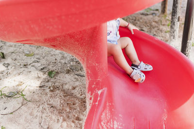 Low section of baby playing on slide