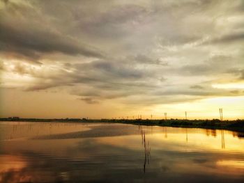 Scenic view of lake against sky during sunset