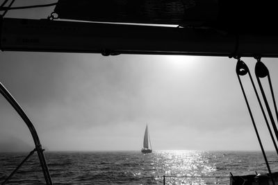 Sailboat sailing on sea against sky