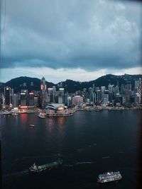 Boats in harbor with buildings in background