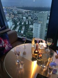 Close-up of wine glass on table in city